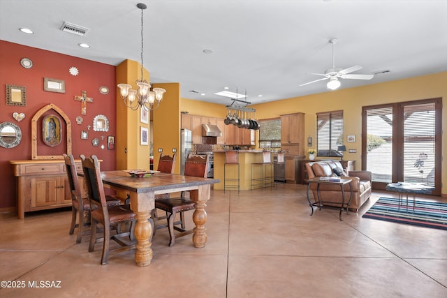 dining area with ceiling fan with notable chandelier, recessed lighting, visible vents, and finished concrete floors