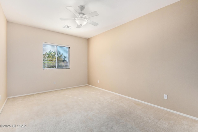 empty room with ceiling fan, baseboards, visible vents, and light colored carpet