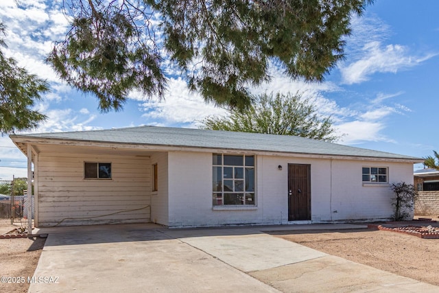 ranch-style house with driveway and brick siding