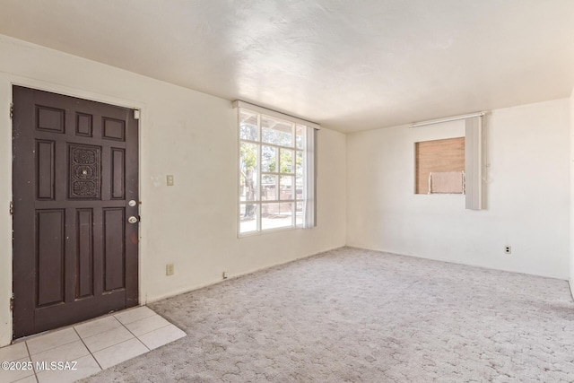 foyer with light colored carpet