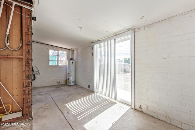 basement with brick wall and water heater