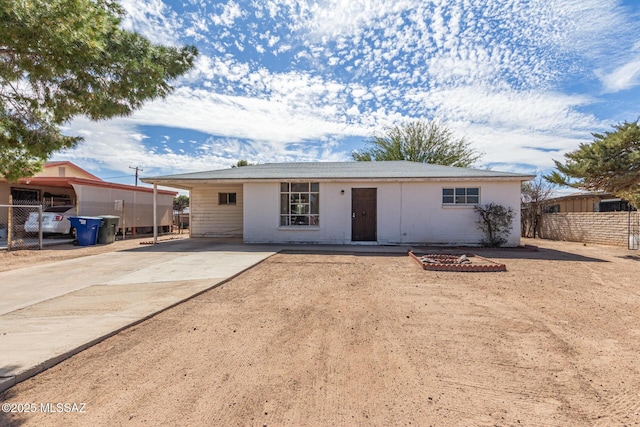 single story home featuring driveway and fence