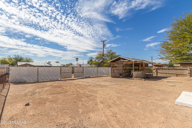 view of yard with an outbuilding and fence