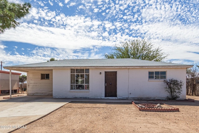 ranch-style house featuring brick siding