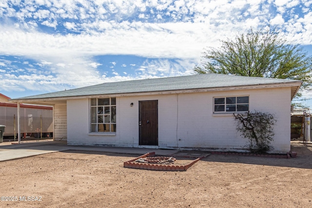 ranch-style home with a patio and brick siding