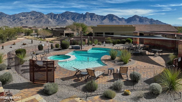 view of pool with fence and a mountain view