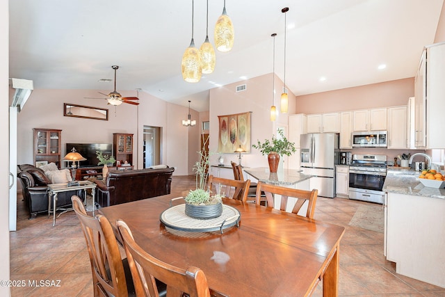 dining room with light tile patterned floors, visible vents, high vaulted ceiling, and ceiling fan with notable chandelier