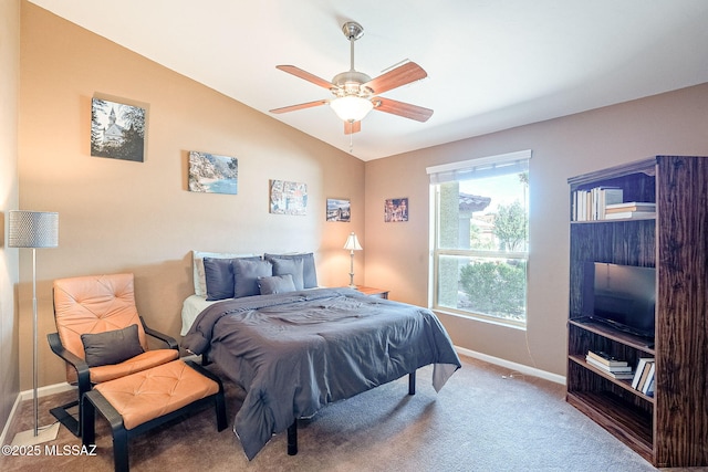 carpeted bedroom with lofted ceiling, ceiling fan, and baseboards