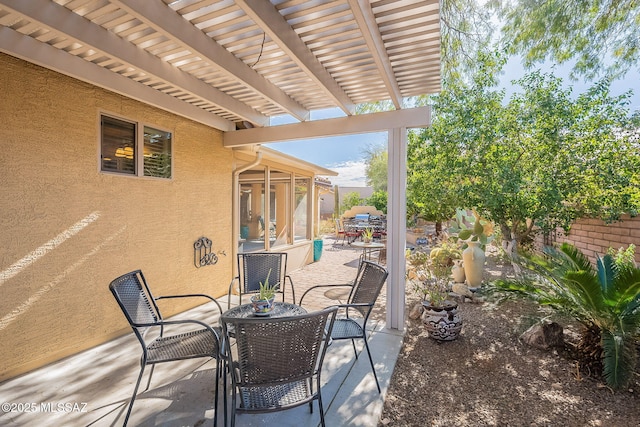 view of patio / terrace featuring outdoor dining area, fence, and a pergola