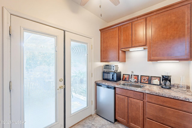 kitchen featuring brown cabinetry, dishwasher, light stone counters, black microwave, and a sink