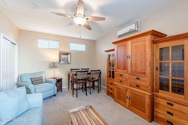 living room featuring baseboards, an AC wall unit, a ceiling fan, and light colored carpet