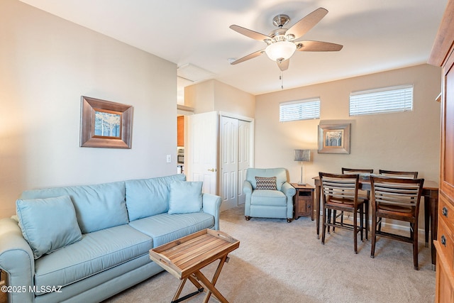 living room featuring light carpet and a ceiling fan