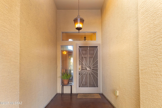 entrance to property featuring stucco siding