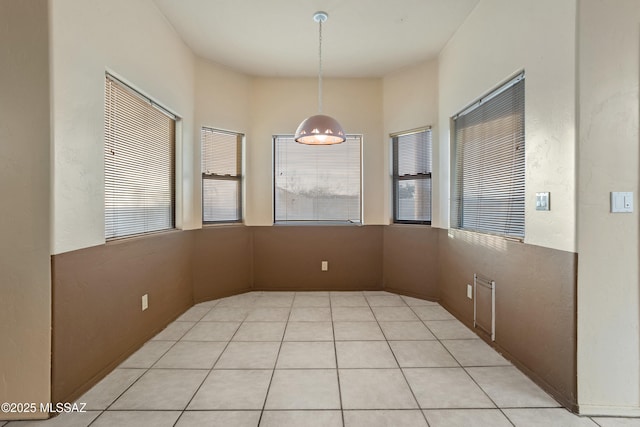 unfurnished dining area with light tile patterned floors