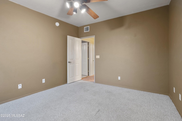 empty room with a ceiling fan, light carpet, visible vents, and baseboards