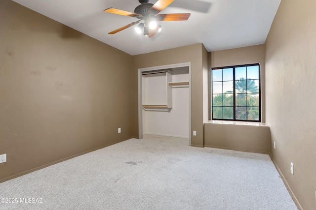 unfurnished bedroom featuring a closet, light carpet, ceiling fan, and baseboards