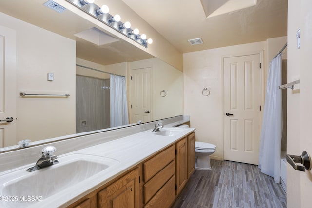 full bathroom with toilet, visible vents, and a sink