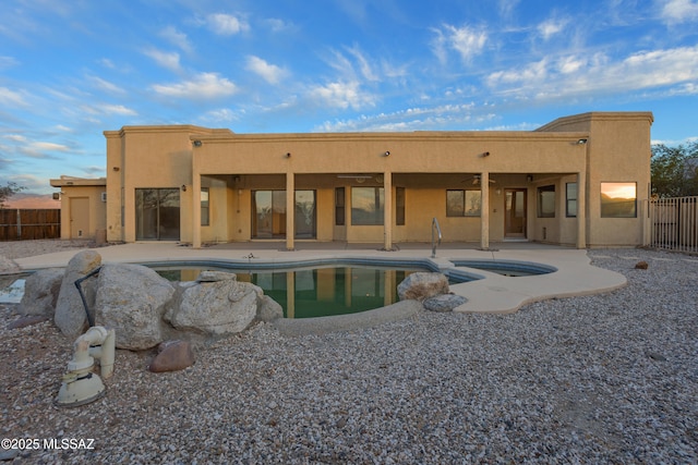 view of pool featuring a fenced in pool, a patio, a ceiling fan, fence, and an in ground hot tub