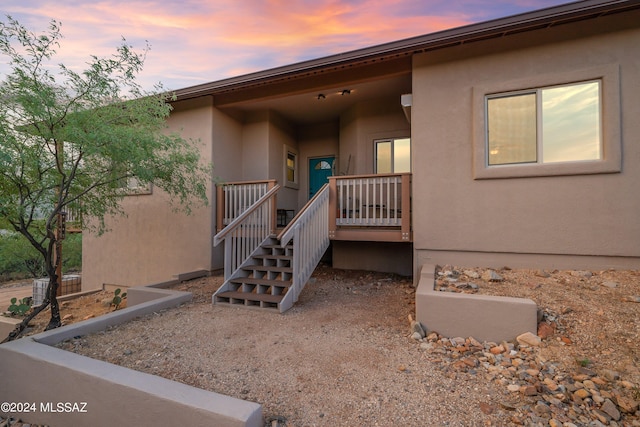 property entrance with stucco siding