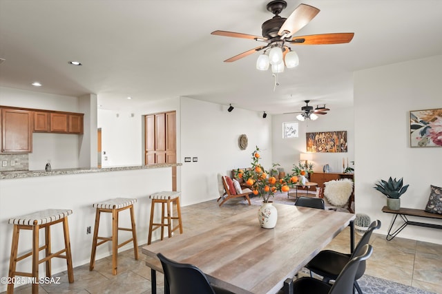 dining area featuring light tile patterned flooring and recessed lighting