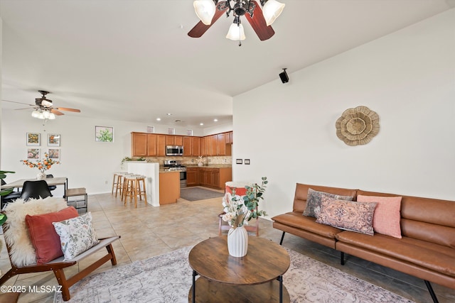 living room featuring light tile patterned flooring, a ceiling fan, and recessed lighting