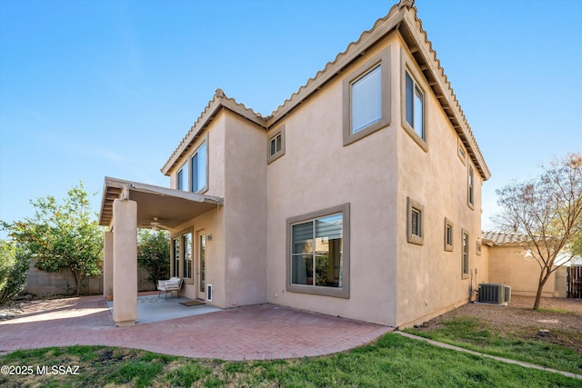 back of property with a patio, cooling unit, a fenced backyard, and stucco siding