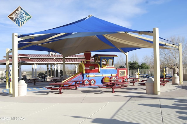 view of home's community featuring fence and playground community