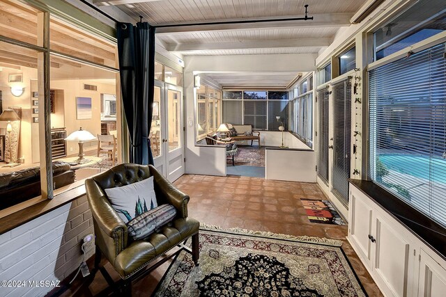 sunroom / solarium featuring visible vents, wood ceiling, and beam ceiling