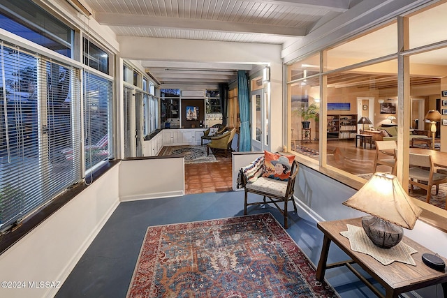 sunroom / solarium featuring beamed ceiling