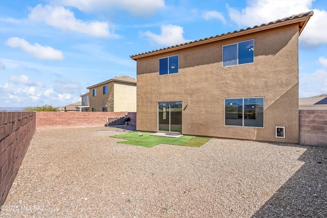 back of house featuring a patio, a fenced backyard, and stucco siding