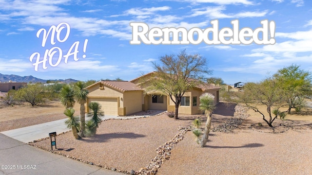 893 N Drystone Ct, Vail, AZ 85641 - view of front facade with a garage, driveway, stucco siding, a tiled roof, and a mountain view