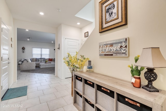 hall featuring recessed lighting and light tile patterned flooring