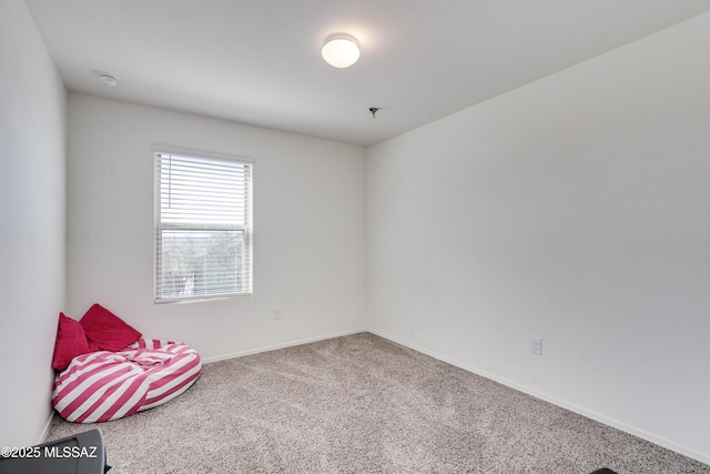 unfurnished room with carpet floors and baseboards