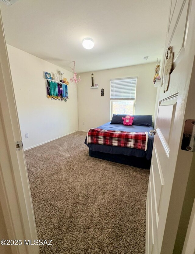 bedroom featuring baseboards, a closet, visible vents, and light colored carpet