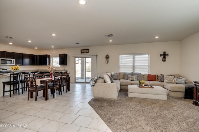 living room with plenty of natural light, visible vents, and recessed lighting