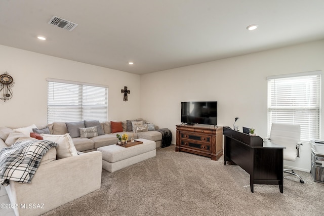 living room featuring light carpet, visible vents, and recessed lighting