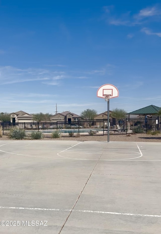 view of basketball court with community basketball court and fence