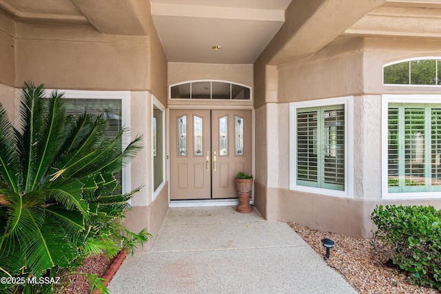 entrance to property featuring stucco siding