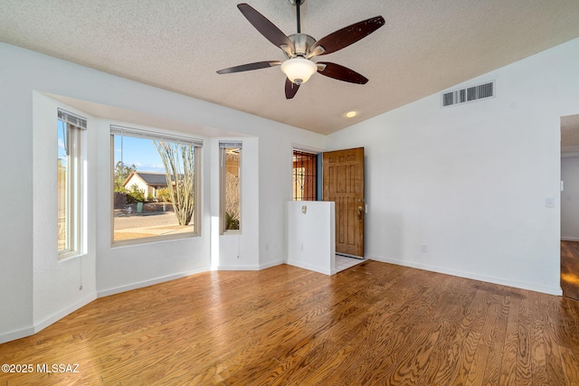9990 E Mary Dr, Tucson, AZ 85730 - empty room featuring lofted ceiling, wood finished floors, visible vents, a ceiling fan, and a textured ceiling
