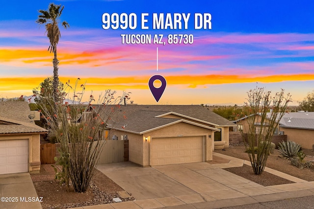 9990 E Mary Dr, Tucson, AZ 85730 - traditional-style house with concrete driveway, an attached garage, fence, stucco siding, and roof with shingles