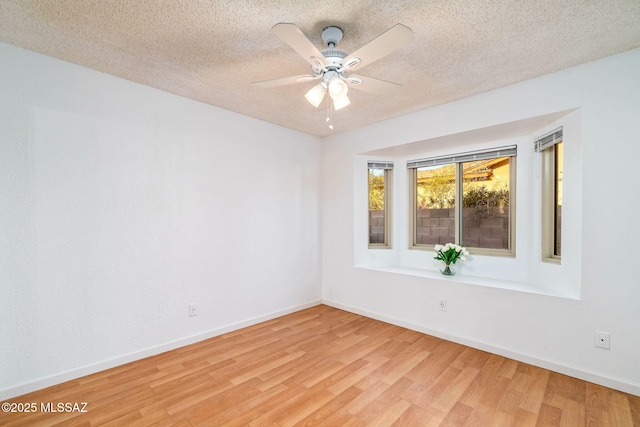 9990 E Mary Dr, Tucson, AZ 85730 - spare room with baseboards, a ceiling fan, a textured ceiling, and light wood-style flooring