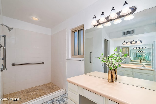 9990 E Mary Dr, Tucson, AZ 85730 - full bathroom featuring a tile shower, visible vents, and vanity