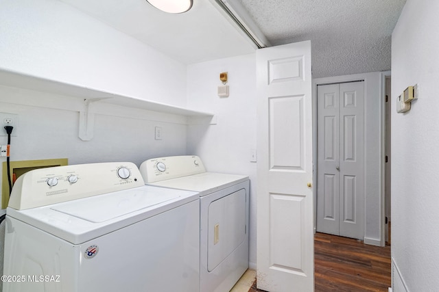 9990 E Mary Dr, Tucson, AZ 85730 - laundry room featuring wood finished floors, a textured ceiling, washer and dryer, and laundry area