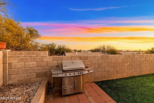 9990 E Mary Dr, Tucson, AZ 85730 - patio terrace at dusk featuring fence and area for grilling