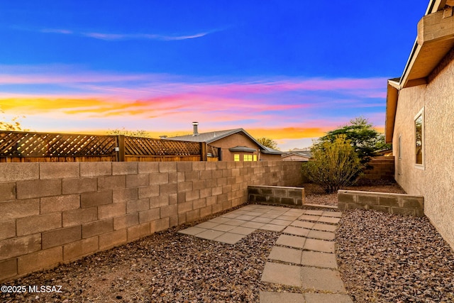 9990 E Mary Dr, Tucson, AZ 85730 - yard at dusk featuring a fenced backyard and a patio area
