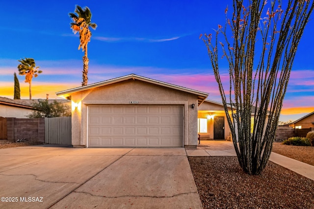 9990 E Mary Dr, Tucson, AZ 85730 - ranch-style home featuring stucco siding, an attached garage, fence, and concrete driveway