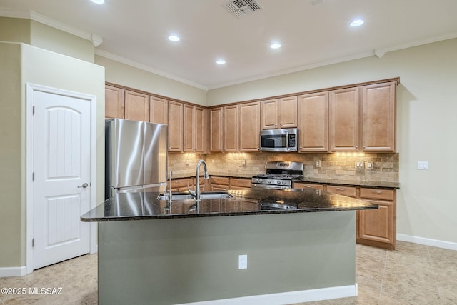 kitchen with visible vents, decorative backsplash, appliances with stainless steel finishes, a sink, and dark stone counters