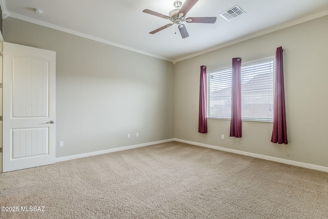 empty room with carpet, visible vents, ornamental molding, ceiling fan, and baseboards