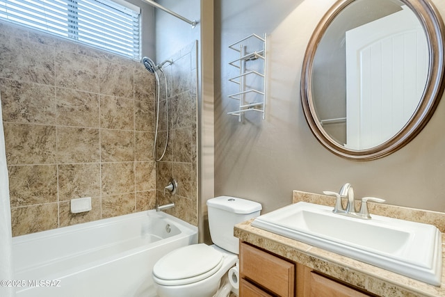 bathroom with toilet, vanity, and shower / tub combination