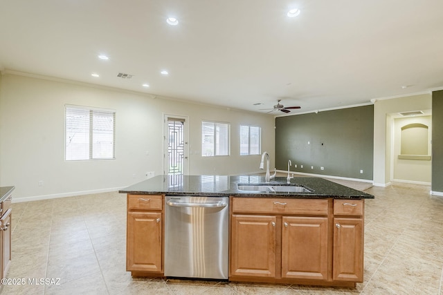 kitchen with dark stone counters, a sink, visible vents, dishwasher, and an island with sink